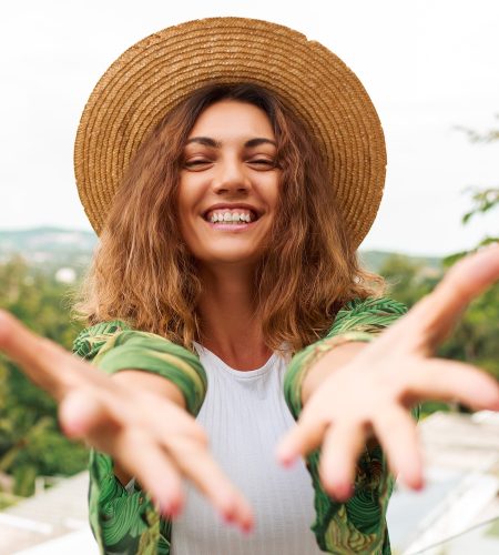 cheerful-woman-straw-hat-having-fun-stretches-hands-camera